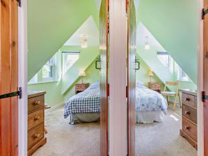 a attic bedroom with two beds and a staircase at 3 bed in Helmsdale SU192 in Helmsdale