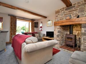 a living room with a stone fireplace at 3 Bed in Ironbridge HWLOC in Buildwas