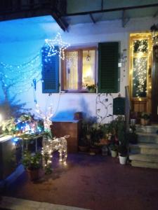 a house with christmas lights on the side of it at Soluna in Maresca
