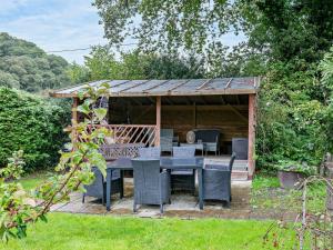 a wooden gazebo with a table and chairs at 2 bed in Barnstaple 28959 in Chapelton