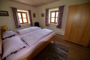 - une chambre avec un lit et 2 fenêtres dans l'établissement Ferienwohnung Kurz, à Rimsting