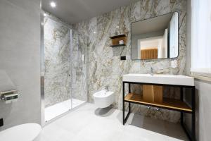 a bathroom with a sink and a mirror at Hotel Mauro in Sirmione