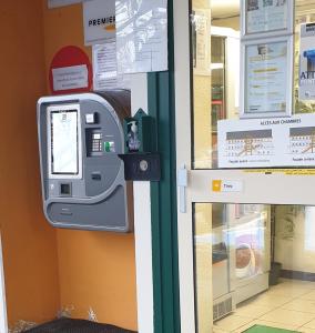 een betaalmeter op de muur van een winkel bij Premiere Classe Brive La Gaillarde Ouest in Brive-la-Gaillarde