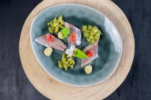 a plate of food with meat and vegetables on it at Villa Cecha B&b &Wellness in Ostend