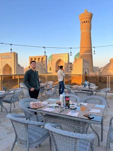 a group of tables and chairs in front of a mosque at GOLDEN MINARET by Terrace in Bukhara