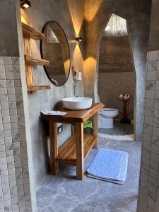a bathroom with a sink and a mirror at Lhong Chiang Dao Glamping หลงเชียงดาว in Chiang Dao