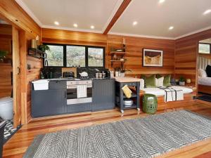 a kitchen with a stove and a counter top at Luxury Solace Cabin - River Cabin in Rawsonville