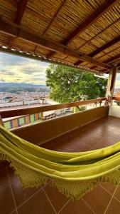 a hammock on a balcony with a view at La Casa del Cerro in Sucre
