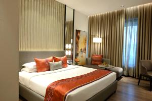 a hotel room with a large bed and a couch at Vivanta Kolkata EM Bypass in Kolkata