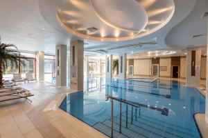 a large swimming pool with a large ceiling at Bonjur Hotel Thermal & Wellness Club in Ankara