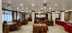 a restaurant with tables and chairs in a room at HOTEL RENDEZVOUS in Gangtok