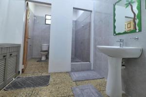 a bathroom with a sink and a shower with a toilet at Inviting 3-Bed Apt in Whim Estate- nearScarborough in Scarborough