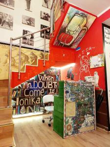 a room with a staircase and paintings on the wall at Hostel Amazing Ionika CenterCity in Chişinău