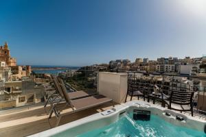 a hot tub on the roof of a building at Maritim Antonine Hotel & Spa in Mellieħa