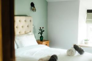 a bedroom with a white bed and a window at Rigney Bank House, South Lakes Luxury Apartments in Milnthorpe