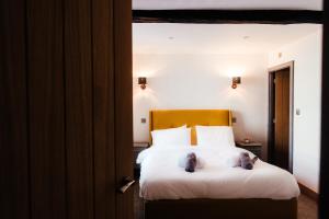 a bedroom with a bed with two stuffed animals on it at Rigney Bank House, South Lakes Luxury Apartments in Milnthorpe