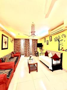 a living room with a couch and a table at Remarkable 3-Bed Apartment in Panjim in Panaji