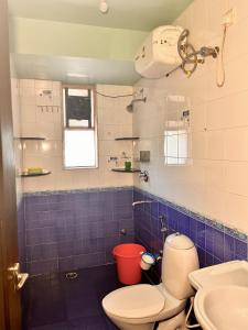 a bathroom with a toilet and a sink at Remarkable 3-Bed Apartment in Panjim in Panaji