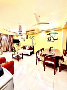 a living room with a table and a couch at Remarkable 3-Bed Apartment in Panjim in Panaji