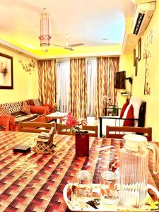 a living room with a table with glasses on it at Remarkable 3-Bed Apartment in Panjim in Panaji