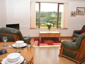 a living room with a table and chairs and a window at 2 Bed in Gower 40481 in Dunvant