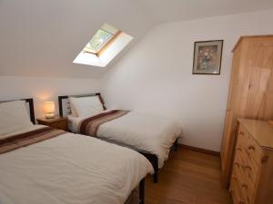 a bedroom with two beds and a skylight at 2 Bed in Gower 40481 in Dunvant