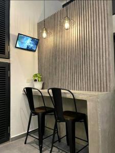 two chairs sitting at a table in a room at [New] Backlane Elegance 5pax Near Jonker 800m in Melaka