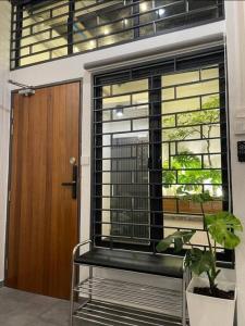 a window with a bench in front of a door at [New] Backlane Elegance 5pax Near Jonker 800m in Melaka +8 photos