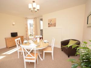 a dining room with a table and chairs at 2 Bed in Bideford 37262 in Bideford