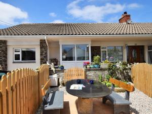 a patio with a table and chairs in front of a house at 1 bed property in Wadebridge Cornwall 42756 in Wadebridge