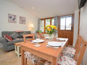 a dining room with a table and a couch at 1 Bed in Abergavenny 47886 in Abergavenny