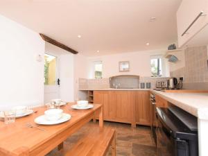 a kitchen with a wooden table with plates on it at 2 Bed in Appledore 53994 in Appledore