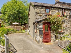 an old stone house with a red door at 1 bed property in Trefriw North Wales 54752 in Trefriw