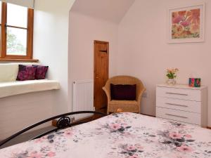 a bedroom with a bed and a chair in it at 2 bed in Petham 55811 in Waltham