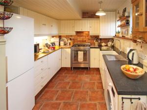 a kitchen with white cabinets and tile flooring at 3 Bed in Whitley Bay CN011 in Backworth