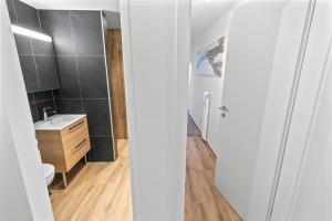 a white bathroom with a sink and a toilet at Appartement rénové avec sauna privé in Saas-Fee +26 photos