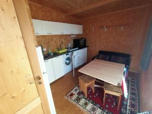a small kitchen with a table and a microwave at Mandulivi, chalet nel mandorleto e mansarda vista mare in Villaggio Azzurro