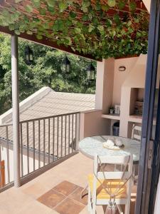 a patio with a table and a balcony with a view at Stay on Lane in Swellendam