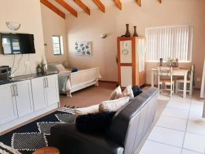 a living room with a couch and a table at Stay on Lane in Swellendam