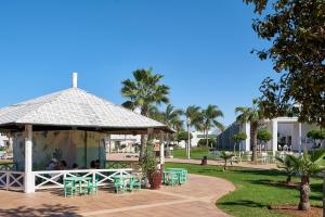 a group of people sitting in a gazebo at Iberostar Saidia in Saïdia