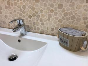 a bathroom sink with a towel in a wooden basket at I Dadi Cielo Alto cir VDA Valtournenche 0446 in Breuil-Cervinia +73 photos