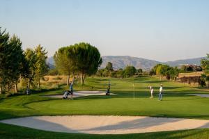 a group of people playing golf on a golf course at Rey Mundo in Munébrega
