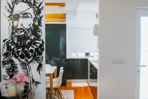 a living room with a painting of a man at Casa Luís de Camões - Boutique & Literary House in Santar