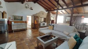 a living room with a couch and a table at Casal do Varatojo in Alcobaça