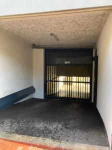 a garage door with a gate in a building at Appartement design au cœur de Montpellier avec parking privé in Montpellier