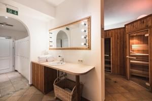 a bathroom with a sink and a mirror at Hotel Goldener Stern in Abtenau