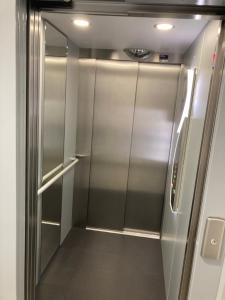 a stainless steel walk in shower in an airplane at Appartement design au cœur de Montpellier avec parking privé in Montpellier
