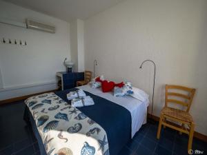 a room with a bed and a chair and a bed sidx sidx sidx at La Lampara Sea View Terrace Apartment in Manarola