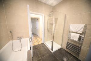 a bathroom with a shower and a bath tub at lfracombe Holiday Apartment Close to Tunnels Beaches in Ilfracombe
