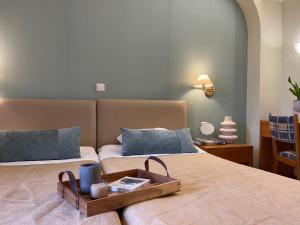 a bedroom with two beds with a tray on the bed at El Greco Hotel in Heraklio
